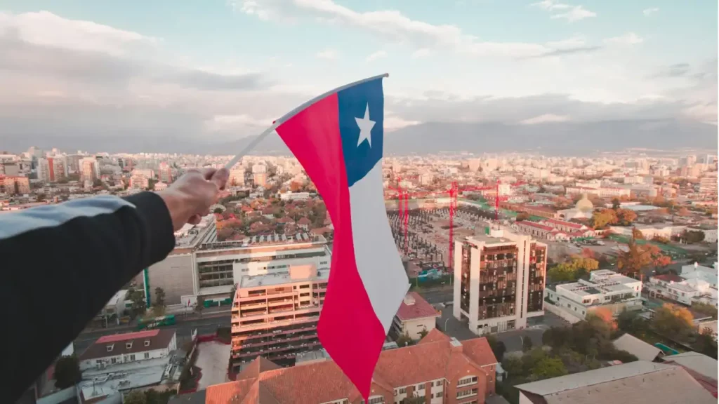 Foto de bandeira do Chile sendo segurada por pessoa